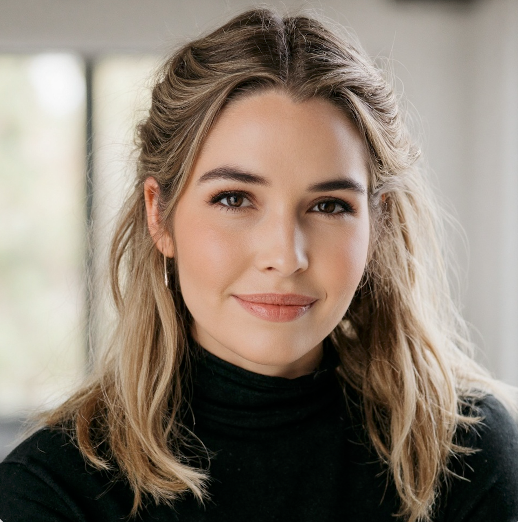 The author — a woman in warm, natural light